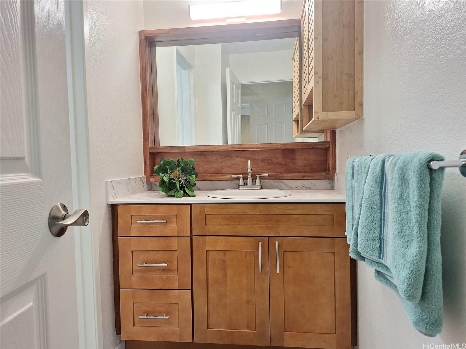 Undisclosed Address Ewa Beach, HI 96706 - Photo 10 of 11 a bathroom with a sink and a mirror