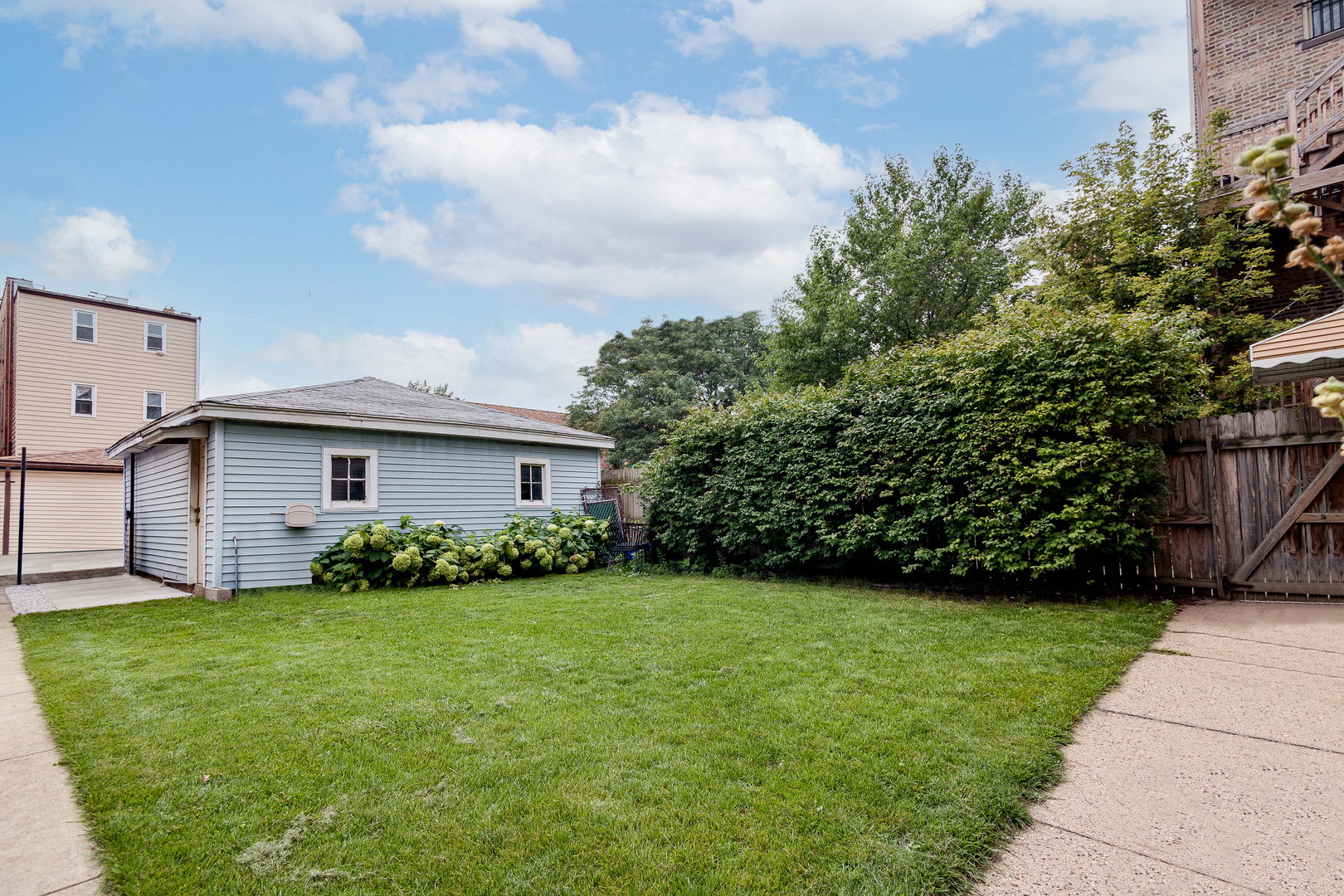 2347 West Walton Street, Unit 2 Chicago, IL 60622 - Photo 10 of 11 a view of a house with a small yard and a large parking space