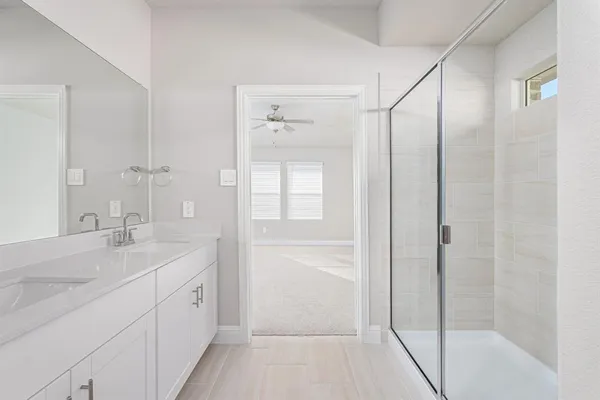 a bathroom with a shower sink and mirror