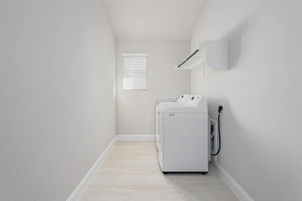 a utility room with a window dryer and washer