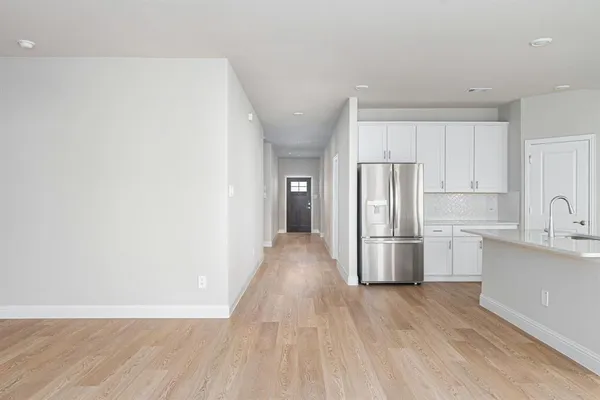 a view of a kitchen with a sink and refrigerator
