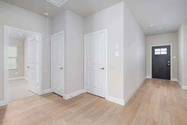 a view of hallway with wooden floor
