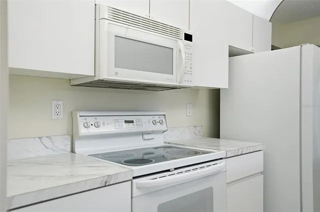 a kitchen with a stove and a microwave