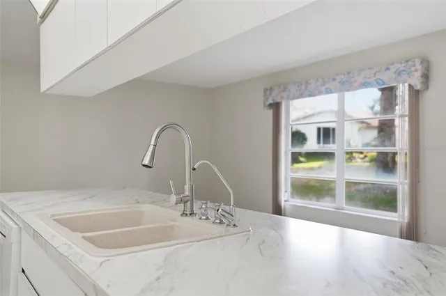 a bathroom with a sink and a large window