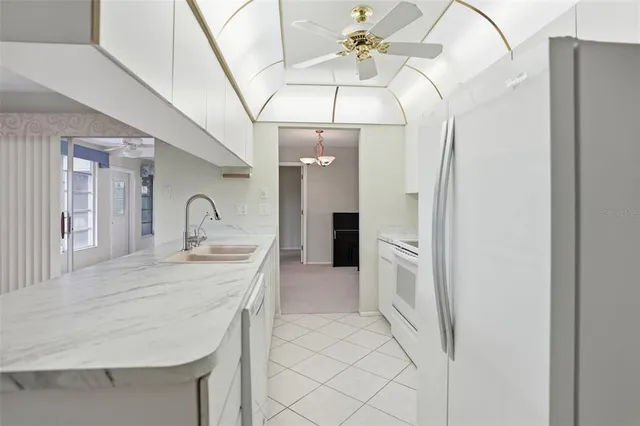 a kitchen with a sink and refrigerator