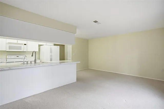 a kitchen with granite countertop a sink and cabinets
