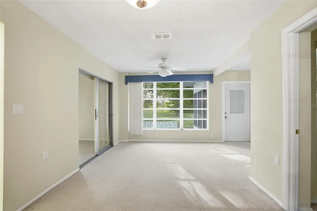 a view of an empty room with a window