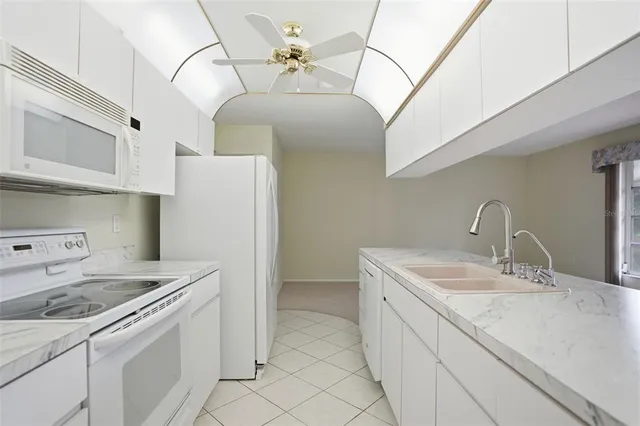 a kitchen with a sink a stove and cabinets