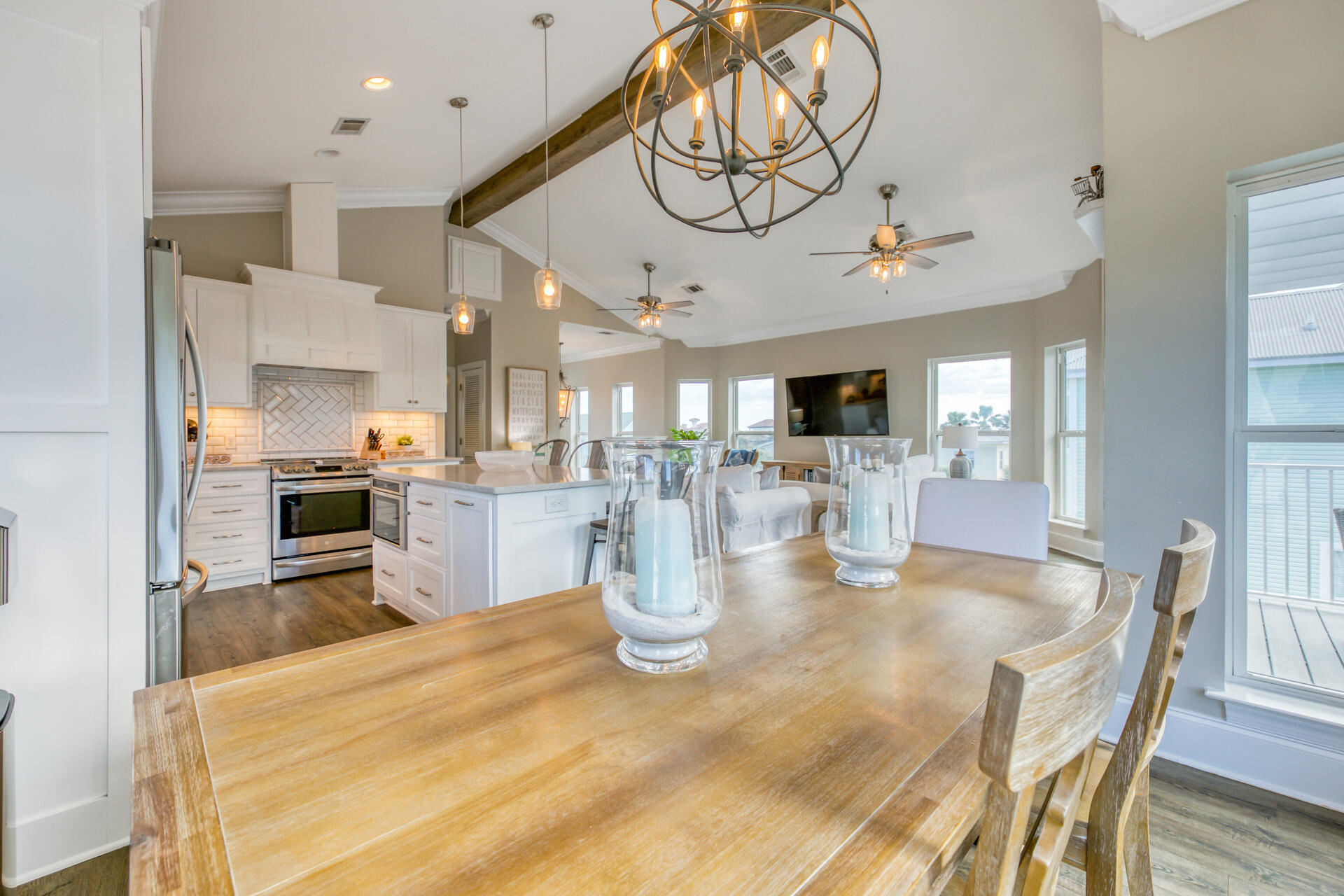 28 Sandcastle Court Santa Rosa Beach, FL 32459 - Photo 16 of 78 a kitchen with stainless steel appliances kitchen island granite countertop a stove top oven a sink dishwasher and white cabinets with wooden floor