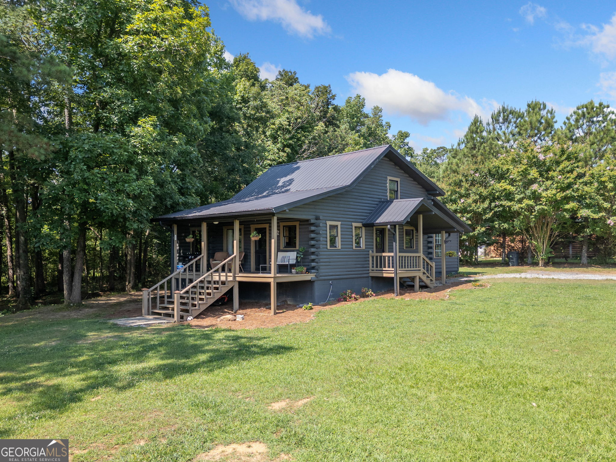 1594 Goswick Road Chatsworth, GA 30705 - Photo 1 of 1 a front view of a house with garden and trees