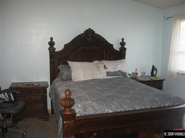 1140 Big Springs Road Reno, NV 89523 - Photo 7 of 9 a bedroom with a bed and a window