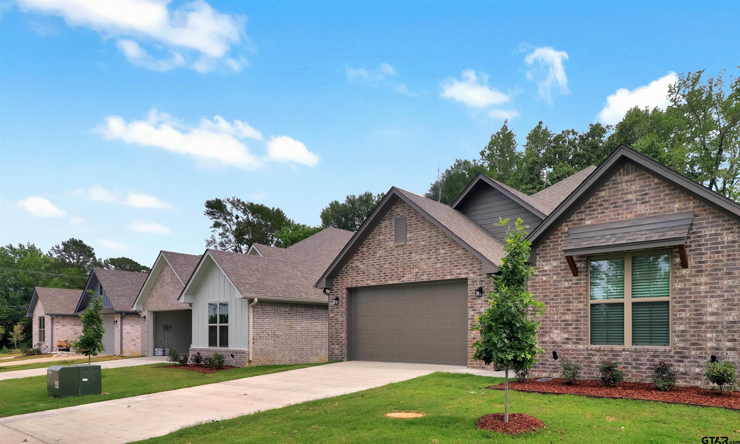 3057 Guinn Farms Road Tyler, TX 75707 - Photo 3 of 32 a front view of a house with garden