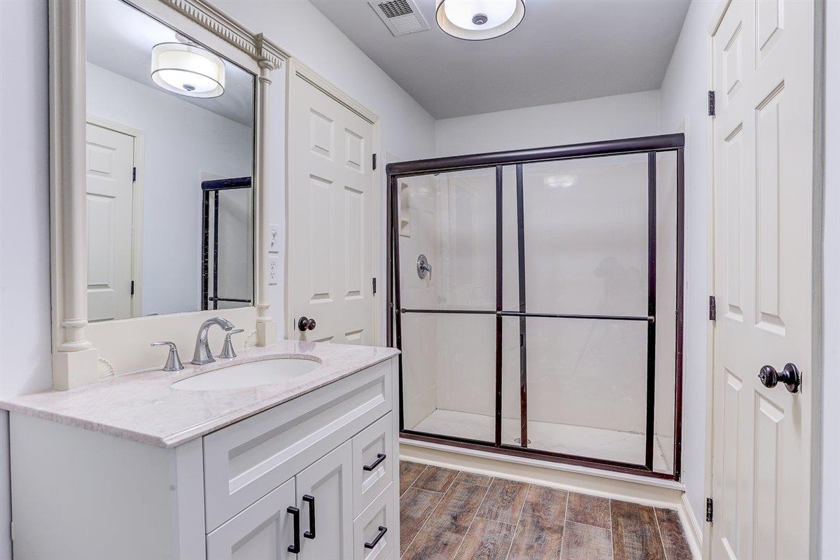 608 Roxburgh Drive Collierville, TN 38017 - Photo 12 of 40 Bathroom with vanity, light wood-style floors, and a shower stall