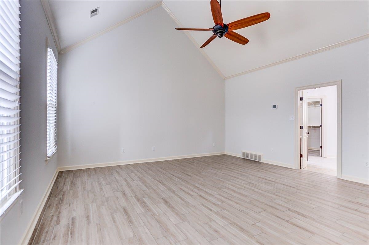 608 Roxburgh Drive Collierville, TN 38017 - Photo 28 of 40 Spare room featuring crown molding, high vaulted ceiling, light wood-style floors, and a ceiling fan