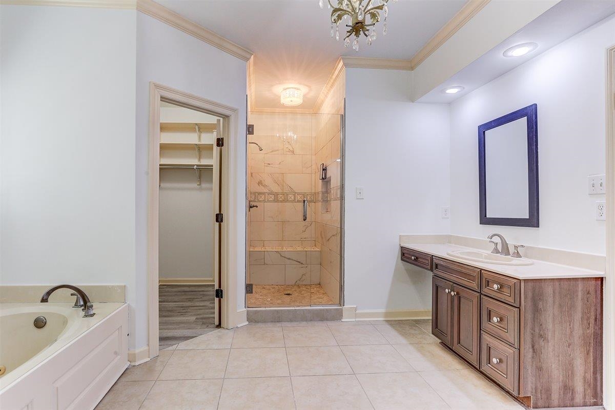 608 Roxburgh Drive Collierville, TN 38017 - Photo 33 of 40 Full bath with ornamental molding, vanity, a bath, a shower stall, and a walk in closet