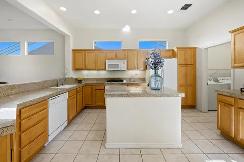 a kitchen with a sink stove top oven and cabinets