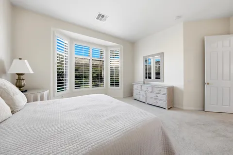 a bathroom with a double vanity sink mirror and shower