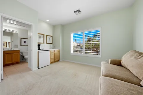 a bathroom with a shower sink vanity mirror and toilet