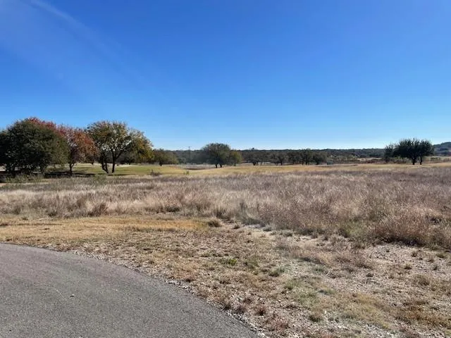 a view of a lake view with beach and house in the background