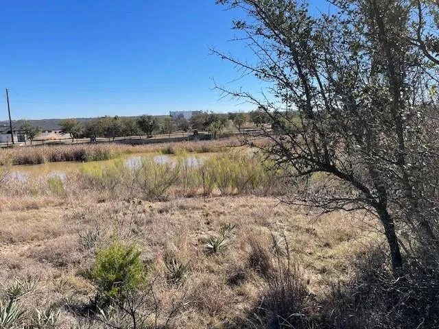a view of a lake with houses in the back