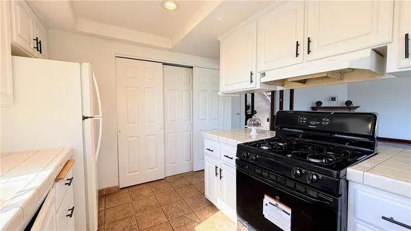 a kitchen with a stove and a refrigerator