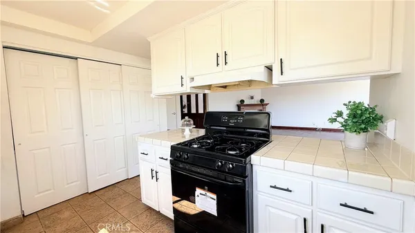 a kitchen with stainless steel appliances white cabinets and a stove