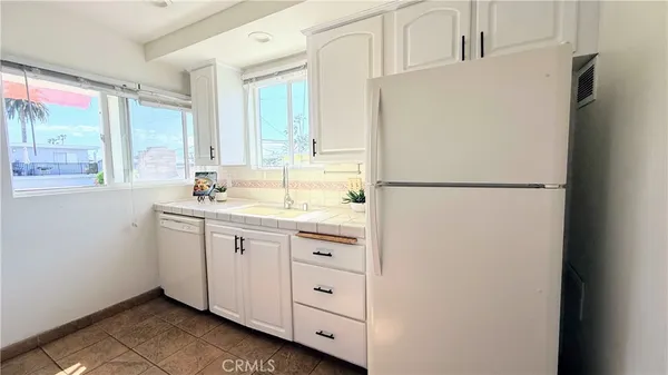a white refrigerator freezer sitting inside of a kitchen