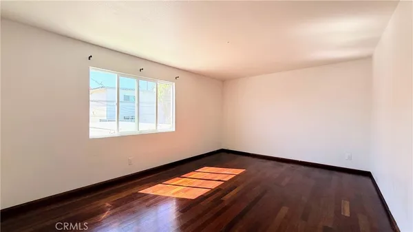 a view of a room with wooden floor and a window