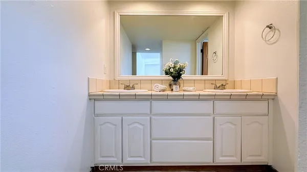 a bathroom with a granite countertop sink and a mirror