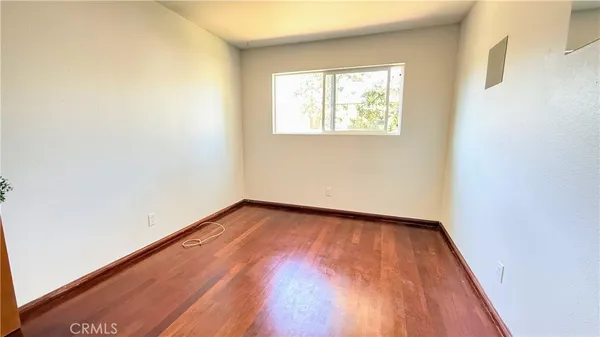 an empty room with wooden floor and closet