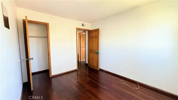 an empty room with wooden floor and a window