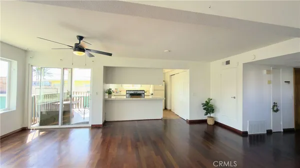 a view of a kitchen with a stove wooden floor and a kitchen
