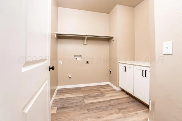 a front view of house with yard and trees in the background