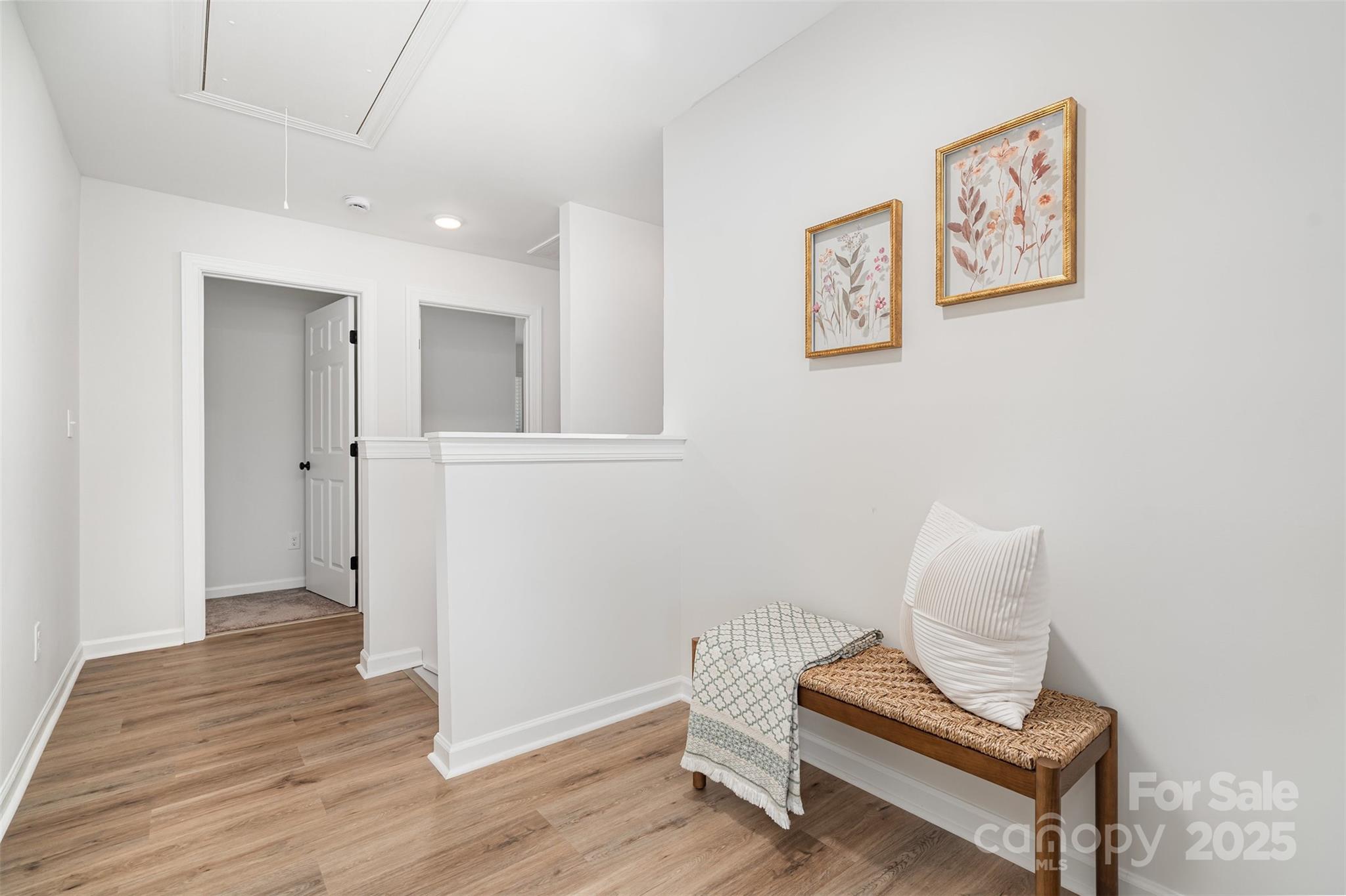 1563 Riverview Circle Fort Lawn, SC 29714 - Photo 11 of 27 a hallway that has painting on the wall with wooden floor
