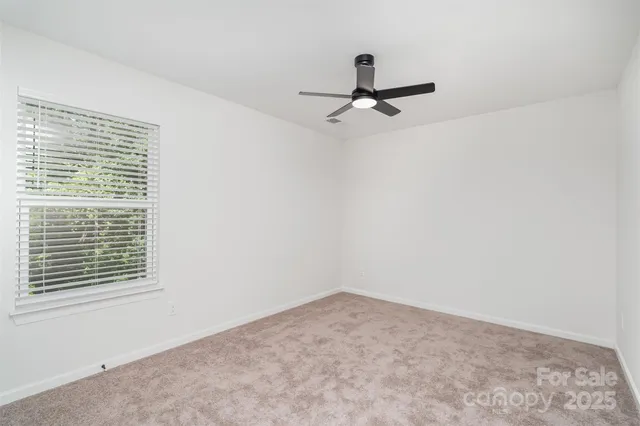 a view of a room with a window and a ceiling fan