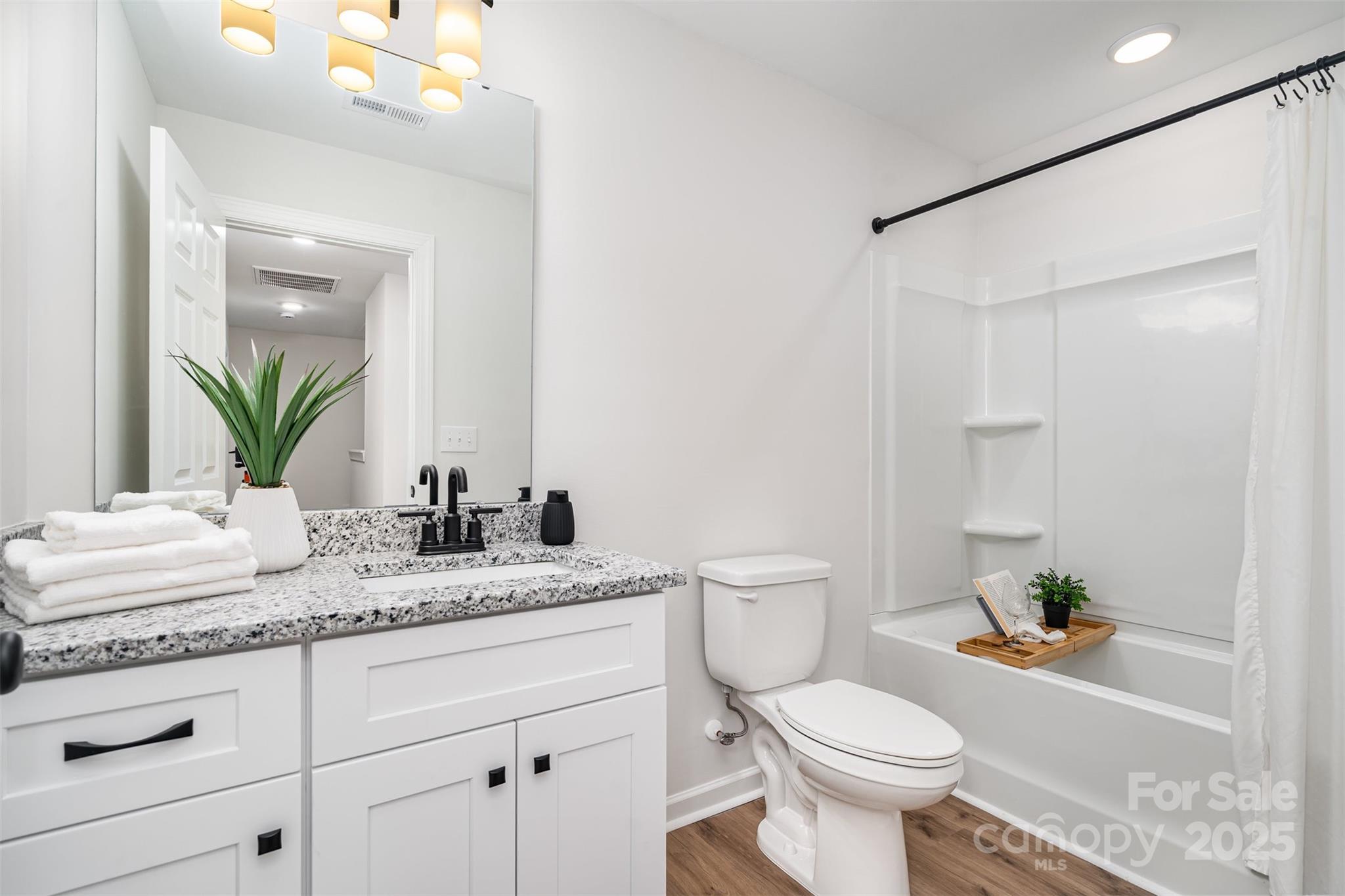 1563 Riverview Circle Fort Lawn, SC 29714 - Photo 18 of 27 a bathroom with a granite countertop sink toilet mirror and shower
