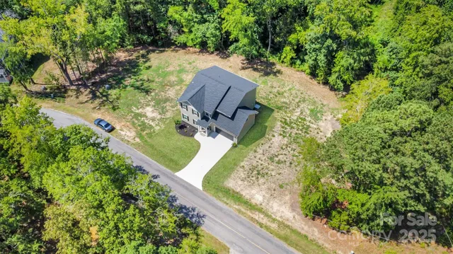 an aerial view of a house with a yard