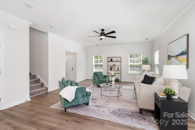 a living room with furniture and wooden floor