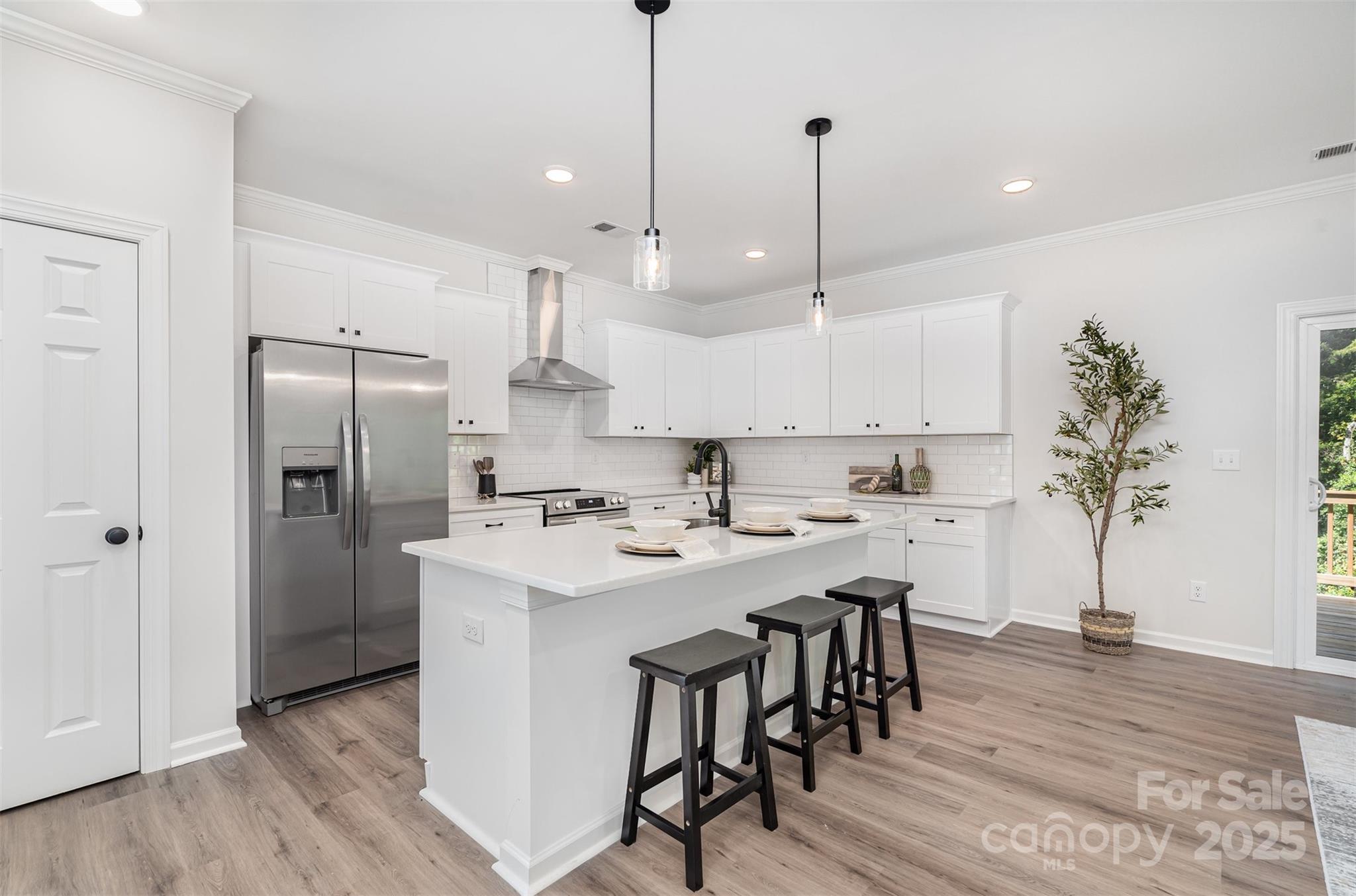 1563 Riverview Circle Fort Lawn, SC 29714 - Photo 6 of 27 a kitchen with kitchen island a refrigerator a stove a sink and a chairs