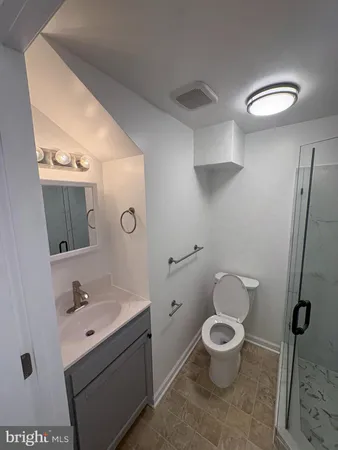 a bathroom with a toilet a sink and shower