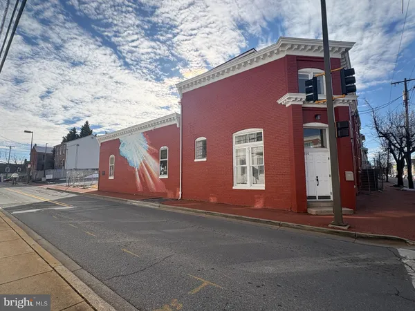 a front view of a building with a road