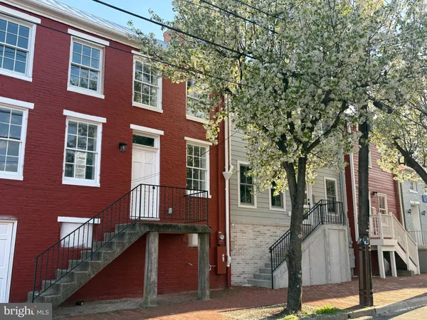 a front view of a building with a tree