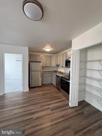 a large room with a bed and dresser