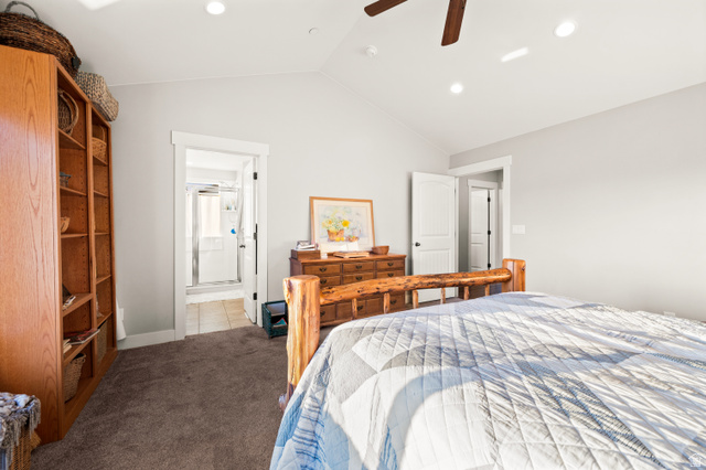 1145 North Christley Lane, Unit 48 Elk Ridge, UT 84651 - Photo 13 of 38 Master bedroom featuring an open doorway to a bathroom with tile flooring and a shower stall