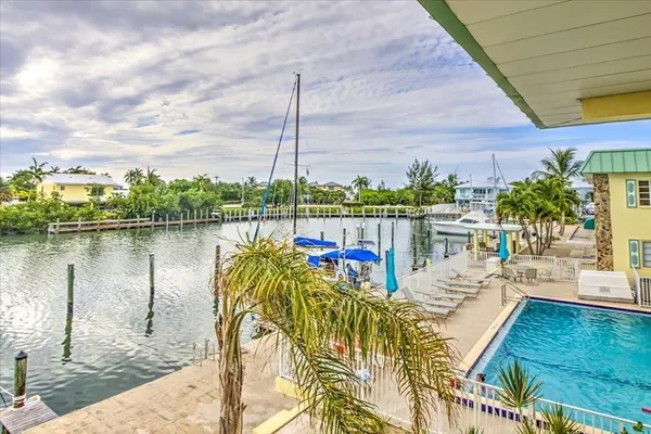 a view of a lake with couches in patio