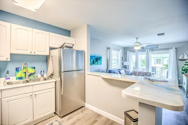 a kitchen with refrigerator and window