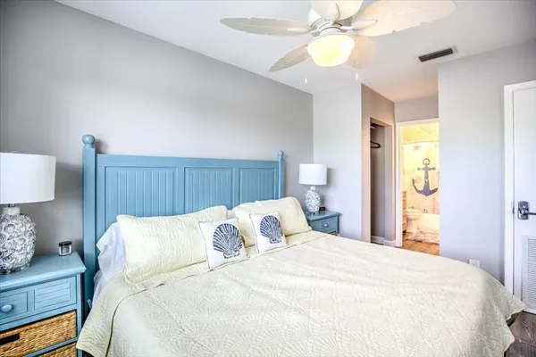 a bedroom with bed and a chandelier