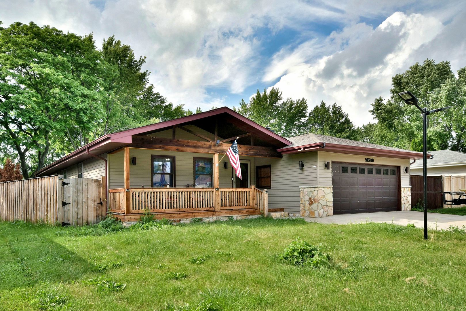 a front view of a house with a garden and yard