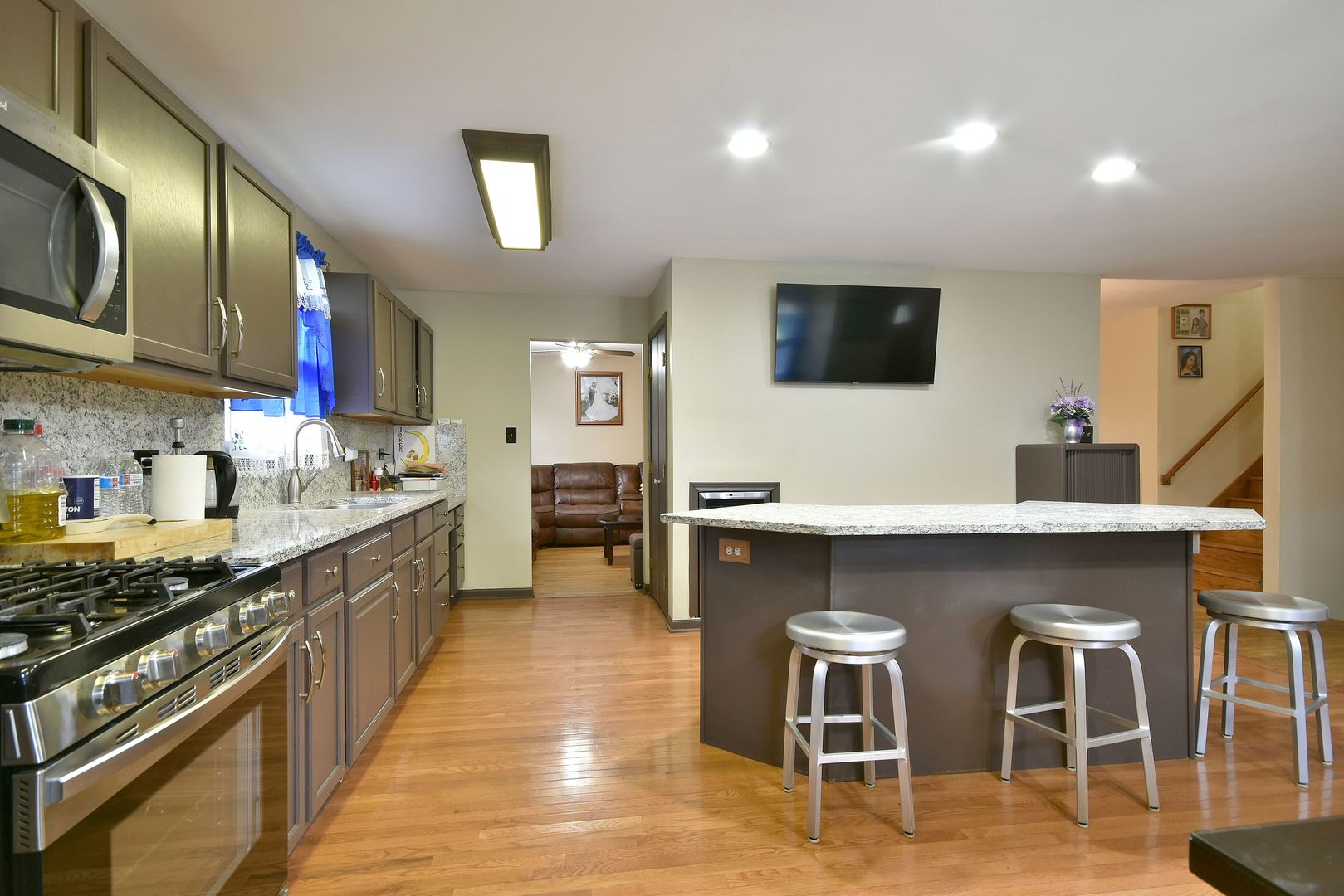 9N590 Flora Drive Elgin, IL 60123 - Photo 11 of 31 a kitchen with stainless steel appliances kitchen island granite countertop a stove a sink and a refrigerator