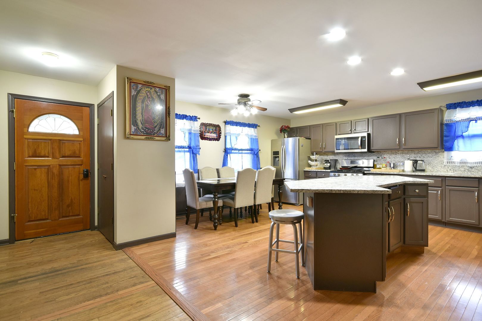 9N590 Flora Drive Elgin, IL 60123 - Photo 3 of 31 a kitchen with stainless steel appliances kitchen island granite countertop a refrigerator and cabinets